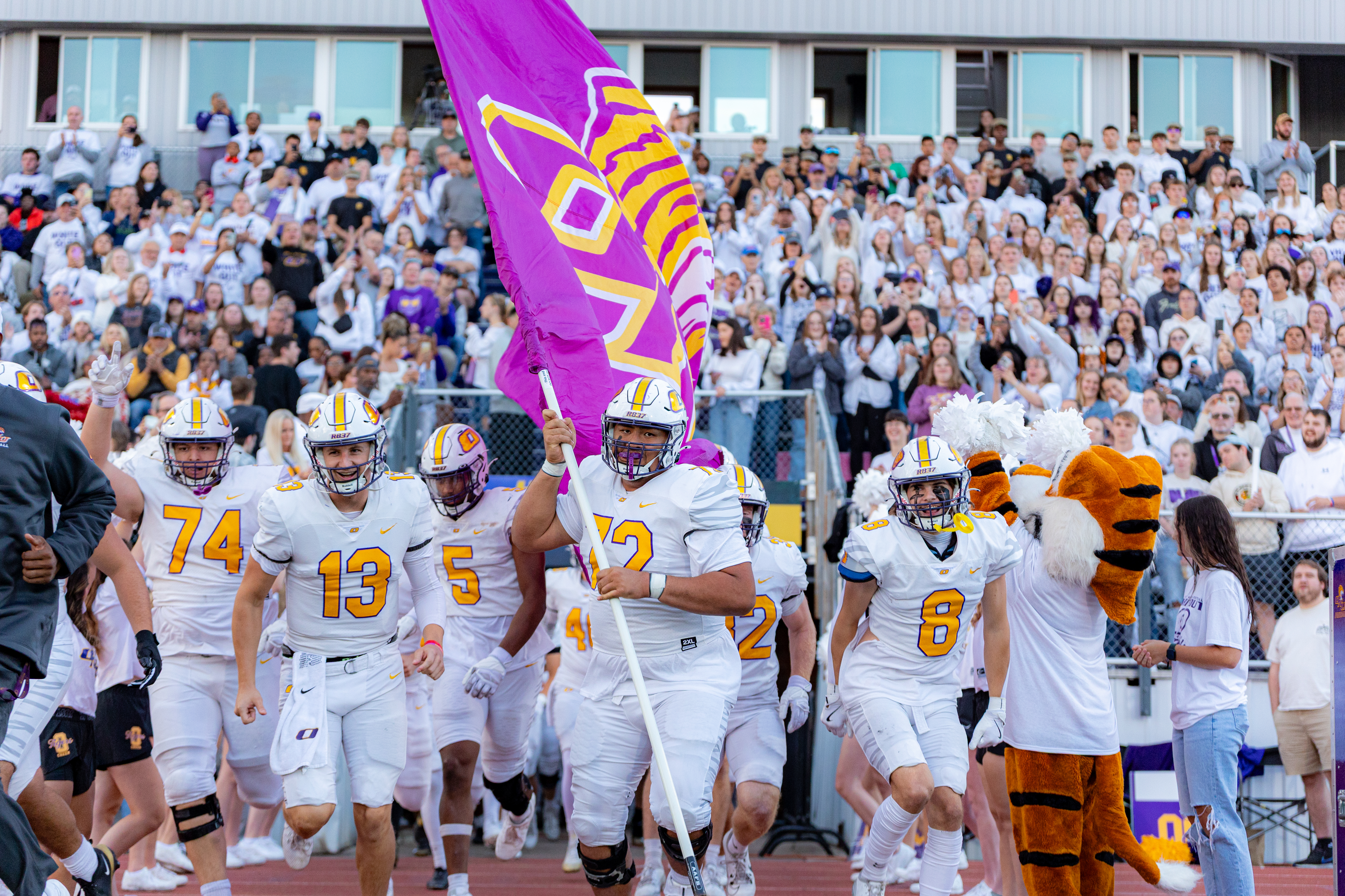Football players running out of the tunnel