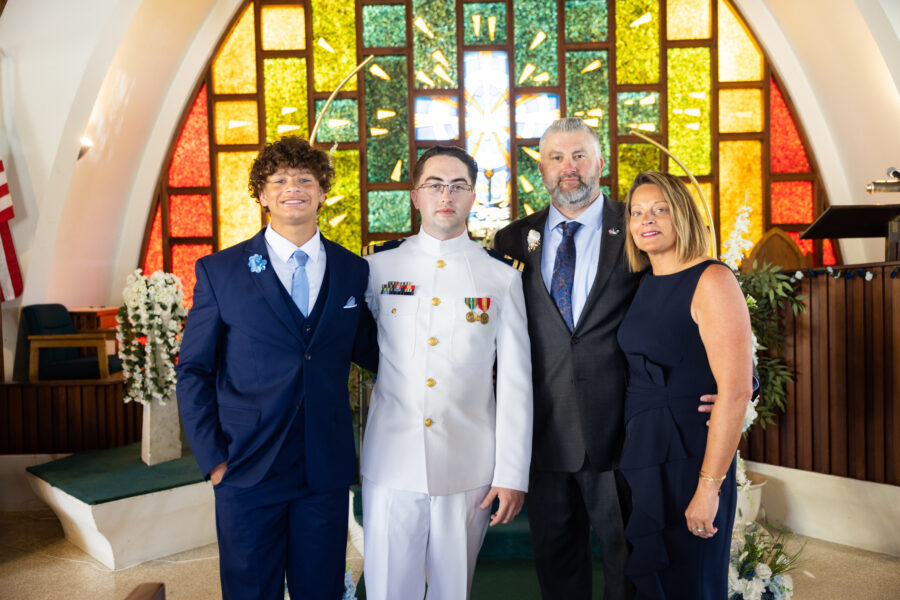 Dennis Nichola with his youngest son and wife at his oldest son's wedding