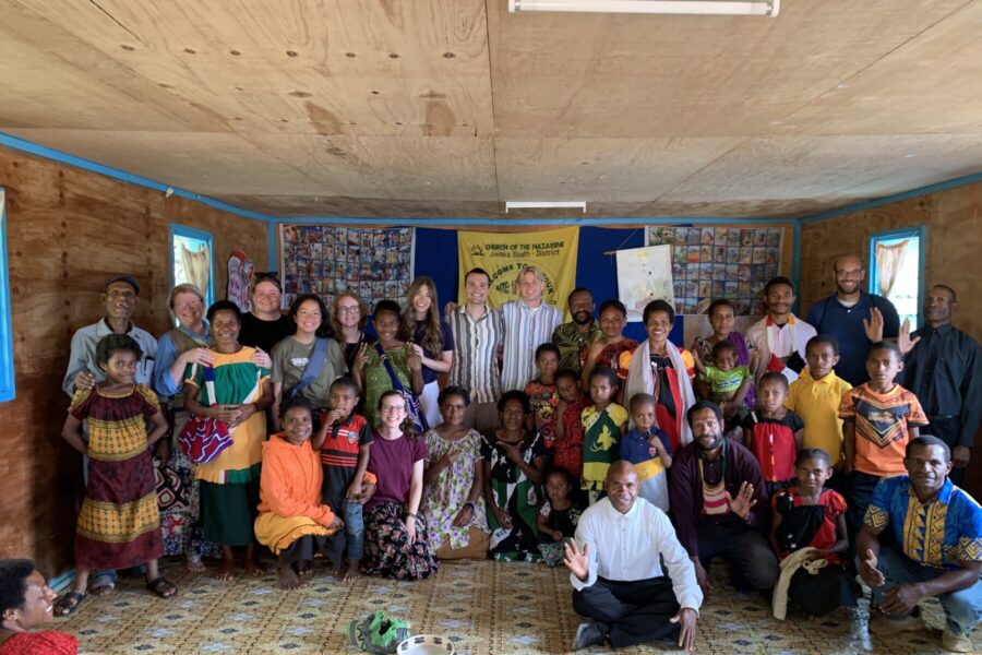 Group of people on a mission trip taking a picture in a building