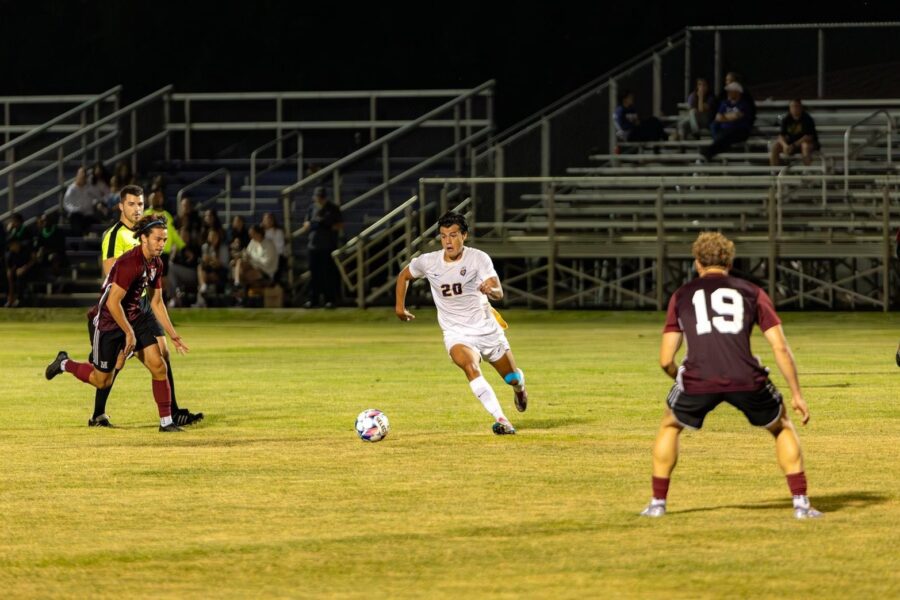 3 men playing soccer