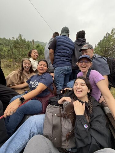 Group of people riding in the back of a truck