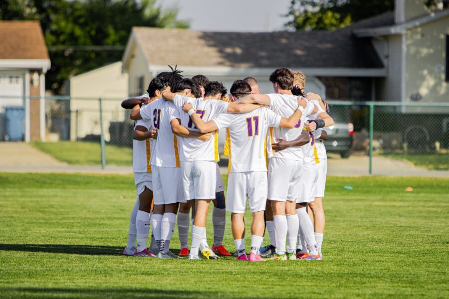 Group of Olivet Soccer players huddled up before kick-off