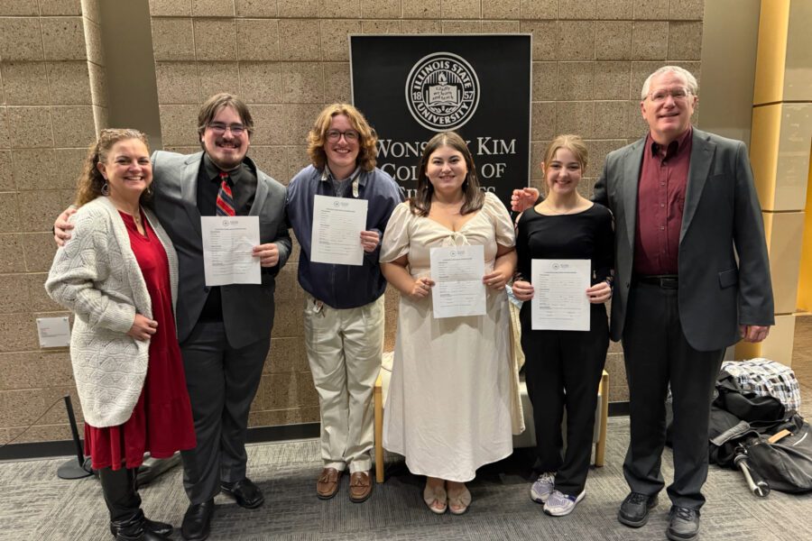 Group of people at an awards show with their awards