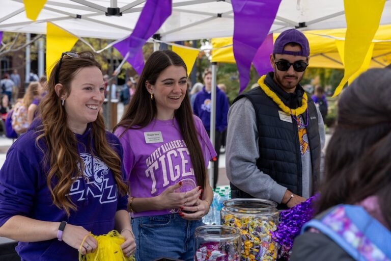 students smiling under tent