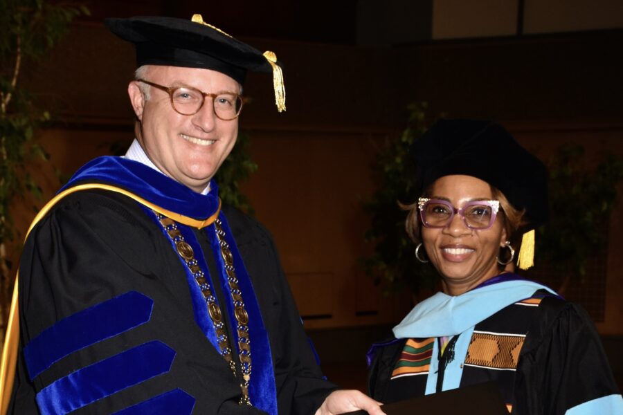 Dr. Chenoweth giving Dr. Regina Smith her Diploma