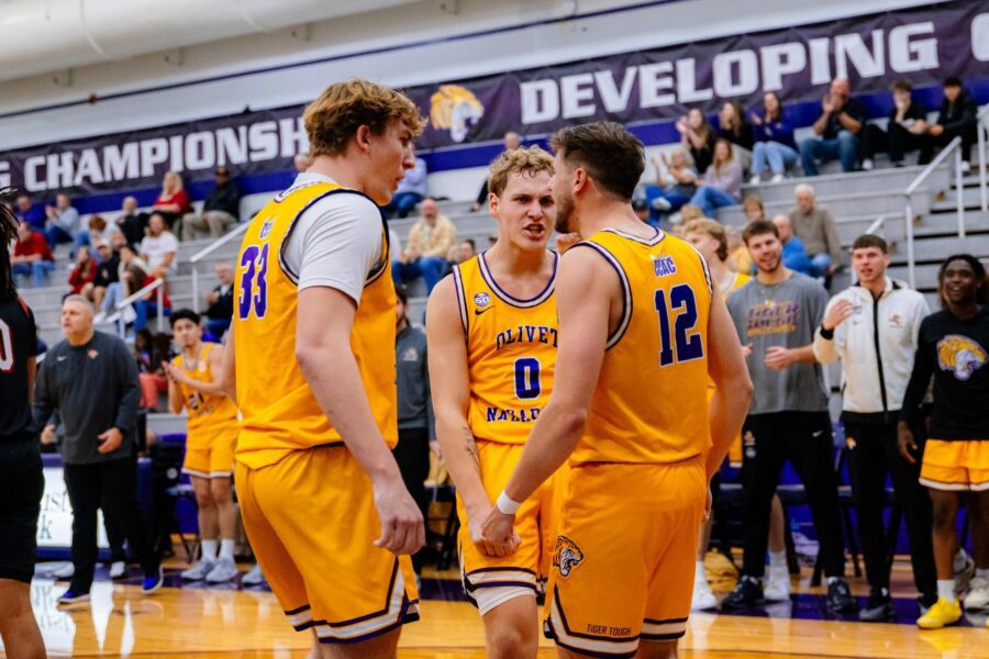 men's basketball players in a huddle
