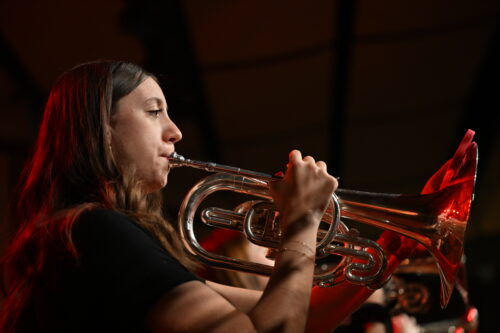 close up photo of a women playing the trumpet