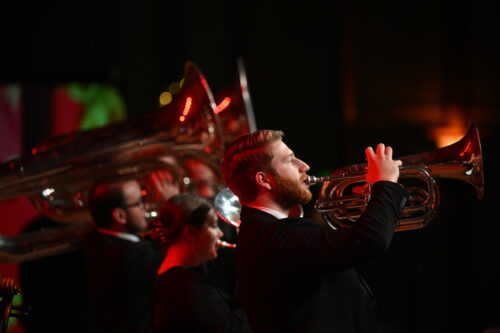 Close up picture of people playing the trumpet