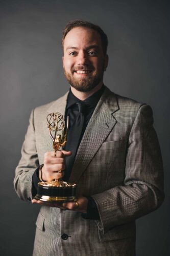 Lucas Hibdon holding his Emmy for a picture