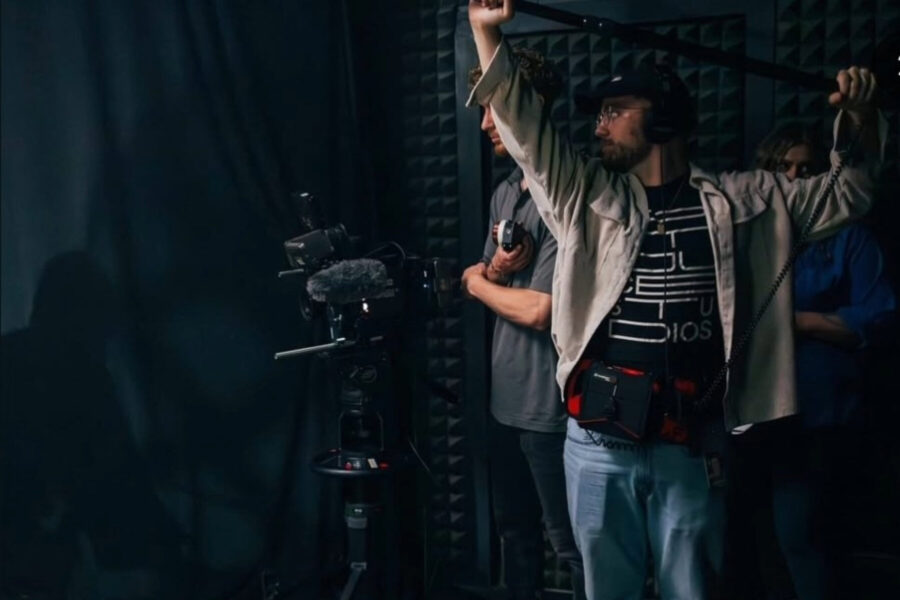 Lucas Hibdon holding a boom mic.