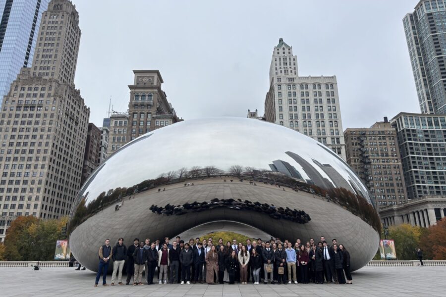 The accounting students and professors standing in front of the Bean in Chicago for a picture.