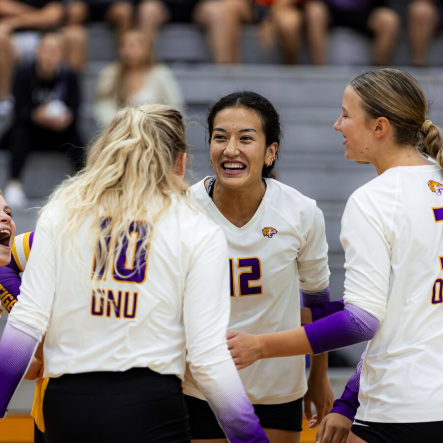 Four women in white ONU volleyball uniforms