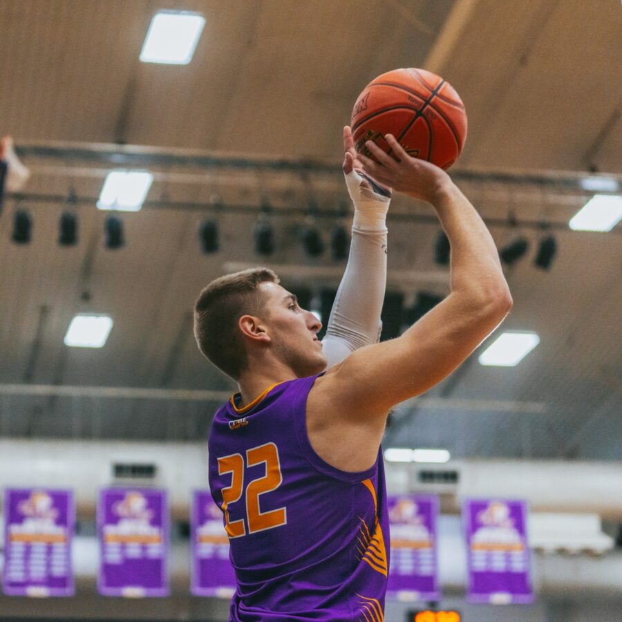 Basketball player in ONU uniform aims the ball
