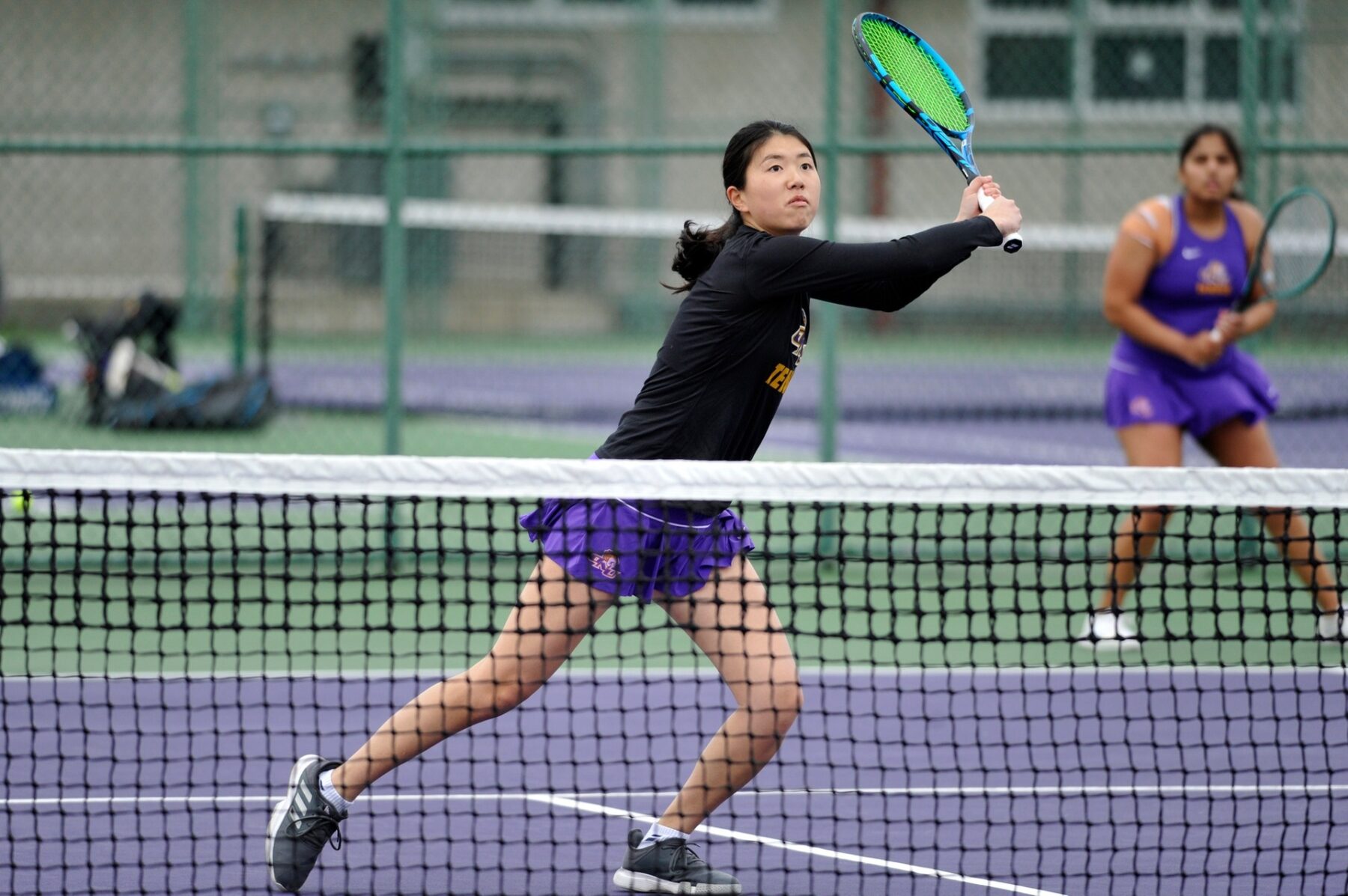 ONU tennis player swings a green racket
