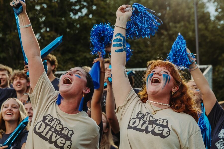 Women students cheering in a crowd to represent our new sport, women's flag football