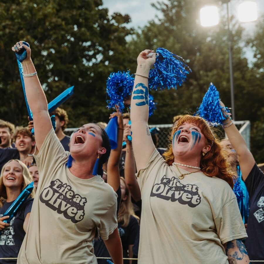 Women students cheering in a crowd to represent our new sport, women's flag football