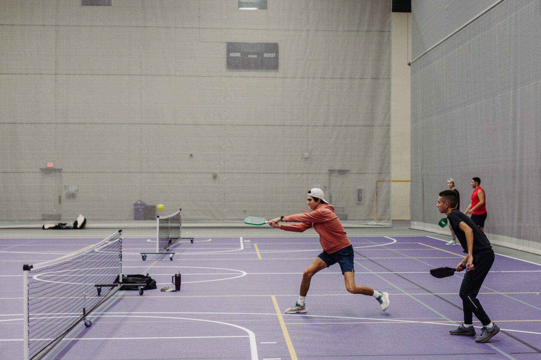 ONU student lunging to hit the ball in our new sport, pickleball