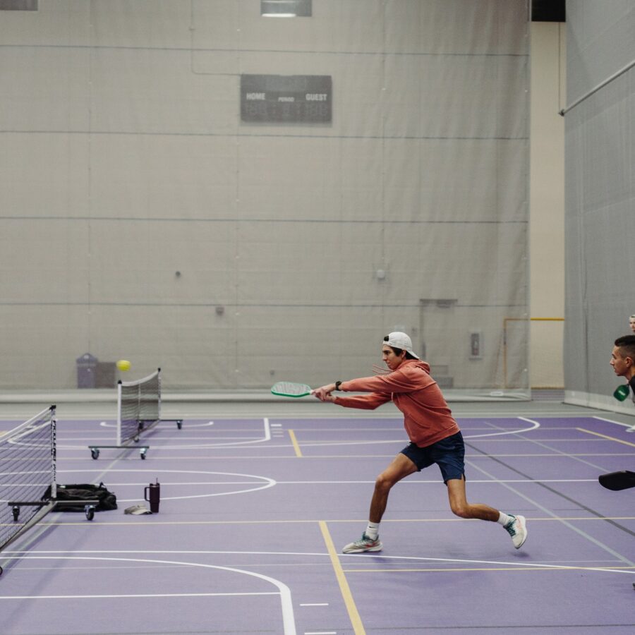 ONU student lunging to hit the ball in our new sport, pickleball