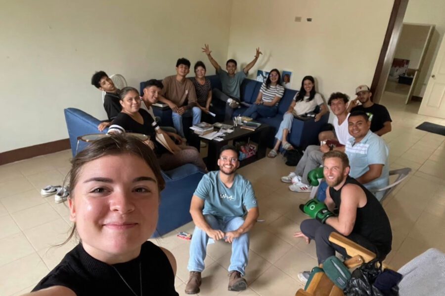 Hope with some people taking a selfie in a living room.