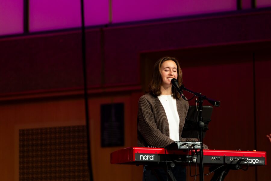 girl playing piano and singing
