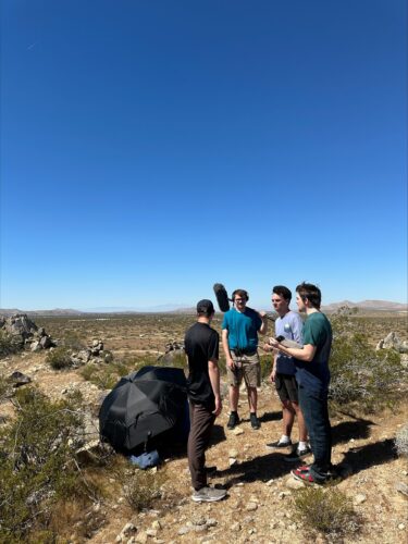Eric and some other guys getting ready to film in an outdoor setting.