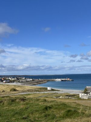 A picture at the top of the hill looking over a body of water.