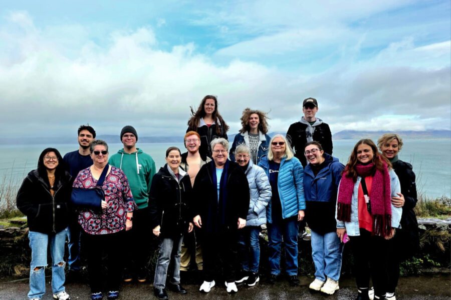 All of the members of the group taking a picture on by the coastline