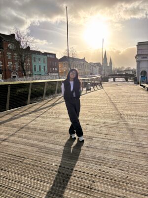 Rylie standing on a walkway next to a river.