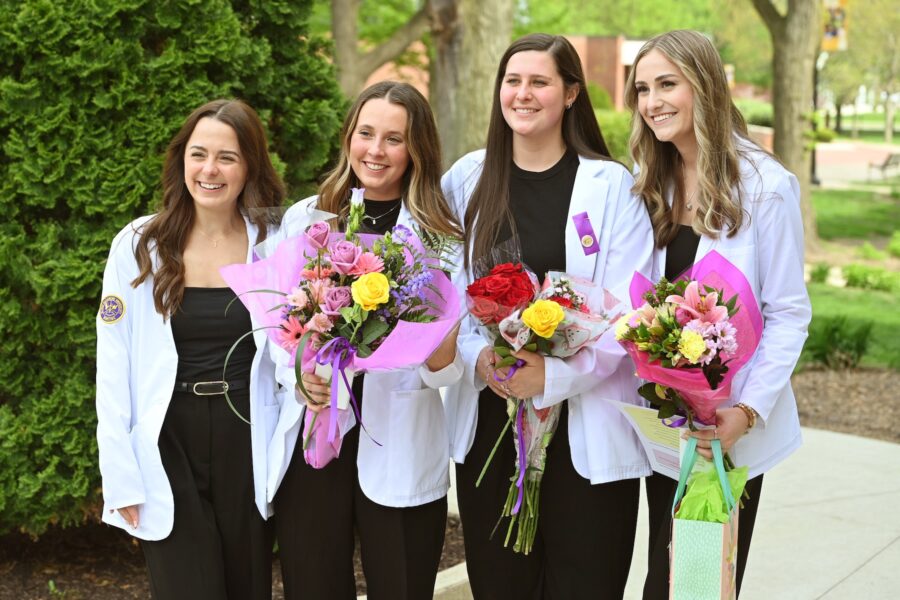 female nursing students holding flowers