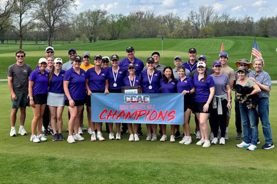 A picture of the Women's golf team with their coaches and families holding the CCAC Championship banner.