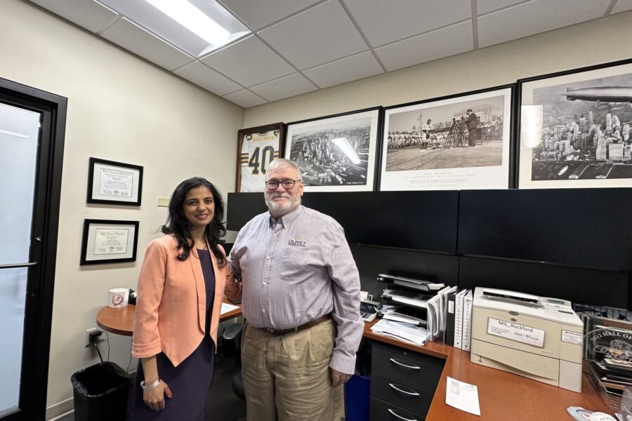 Greg with a leader from EAL standing in a office for a picture.