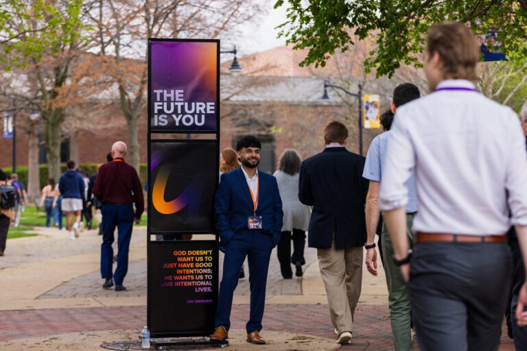 A picture of people walking into a main session of the confrence