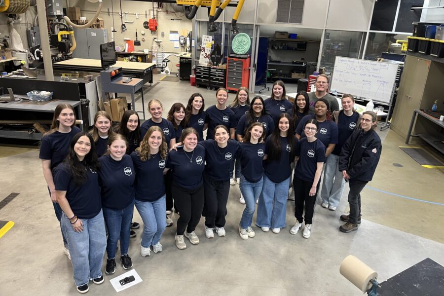Everyone participating in Introduce a Girl to Engineering Day in a lab for a group picture.