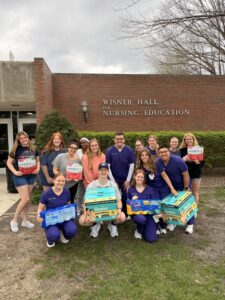 A picture of nursing students with donations.