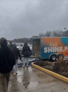 A picture of Shine and them putting the donations in a trailer.