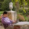 A student studying outside on an outdoor table
