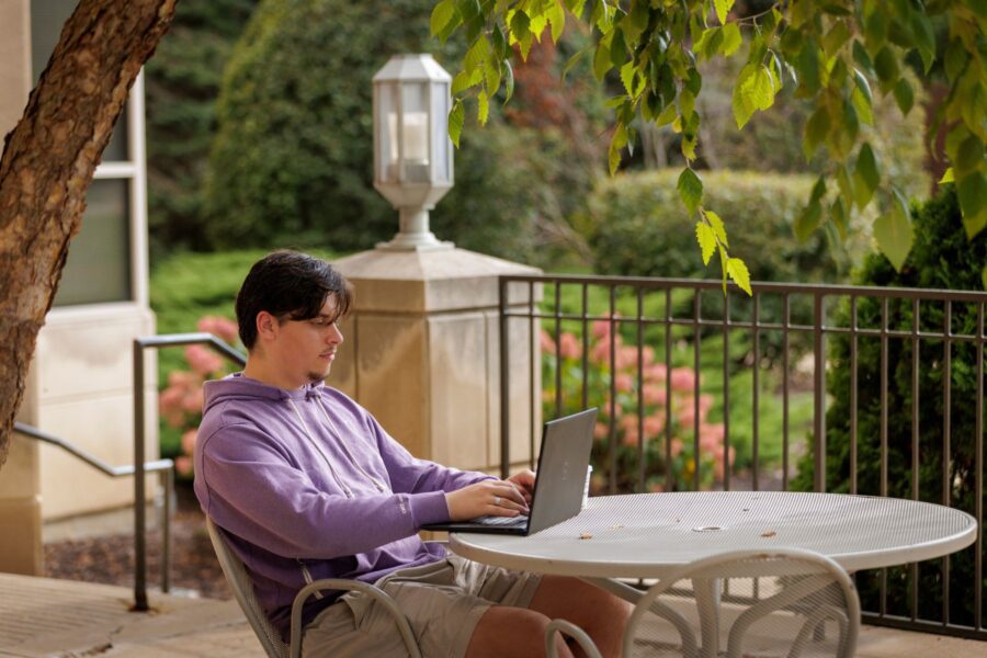A student studying outside on an outdoor table