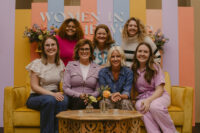 Group leaders of women in the Word are taking a picture on a couch.