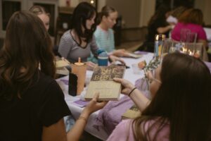 A group of girls is doing some crafts
