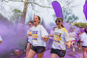 People running through the chalk in the air at Olivet's color run.