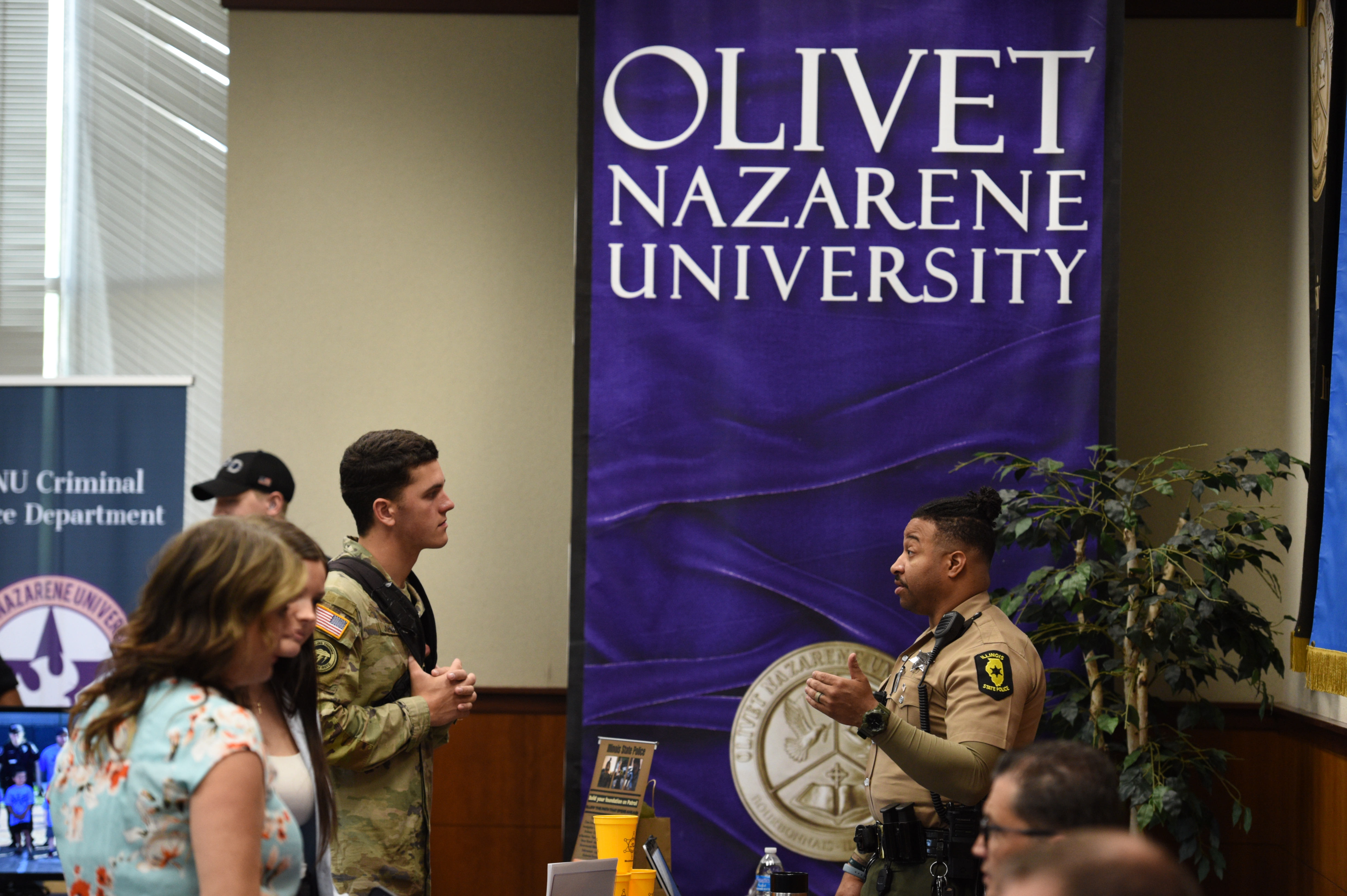 A picture of students talking to one of the agencies at the career fair.