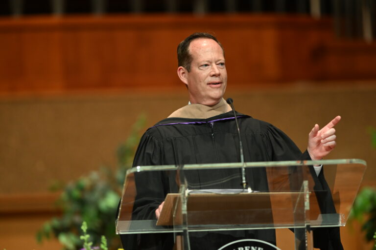 A picture of Matt speaking on stage