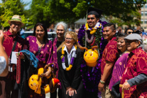 Picture of people outside with a graduate.