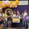 People standing in the day of giving photo booth.