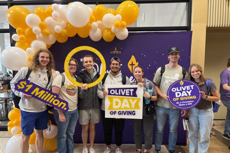 People standing in the day of giving photo booth.