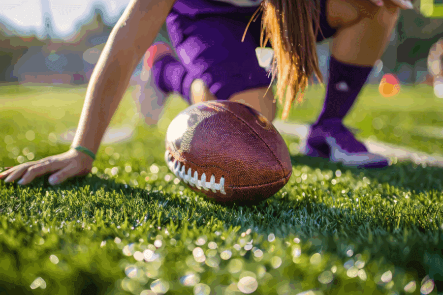 A picture of a girl playing flag football.