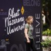 girl standing in front of olivet banner
