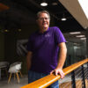 A picture of Scott Ragan standing next to a railing.