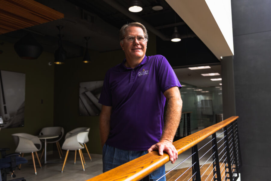 A picture of Scott Ragan standing next to a railing.