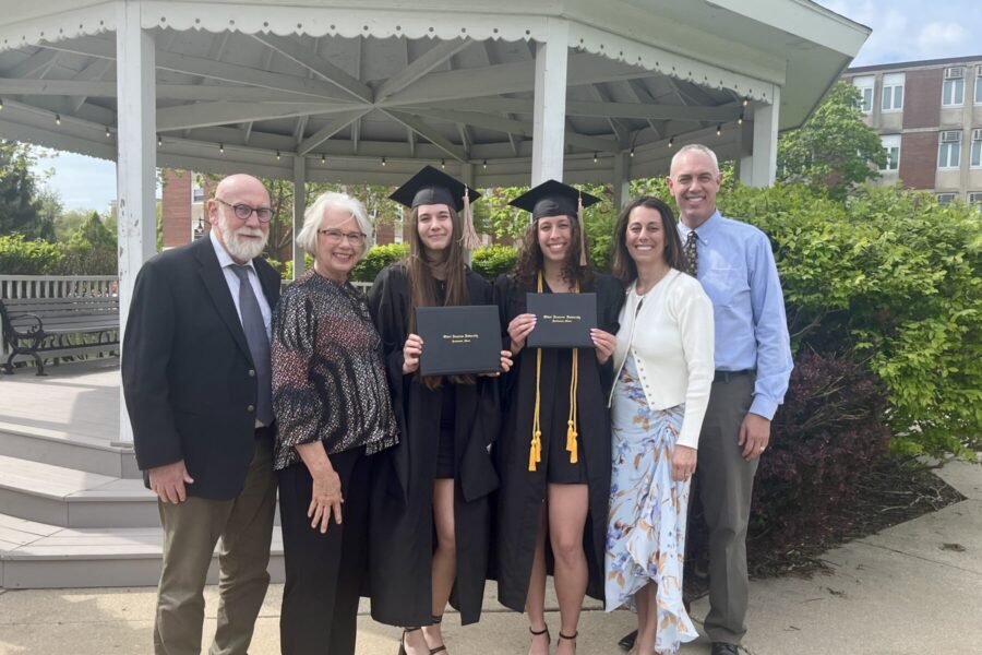 Mia with her sister, parents and grandparents after graduating.